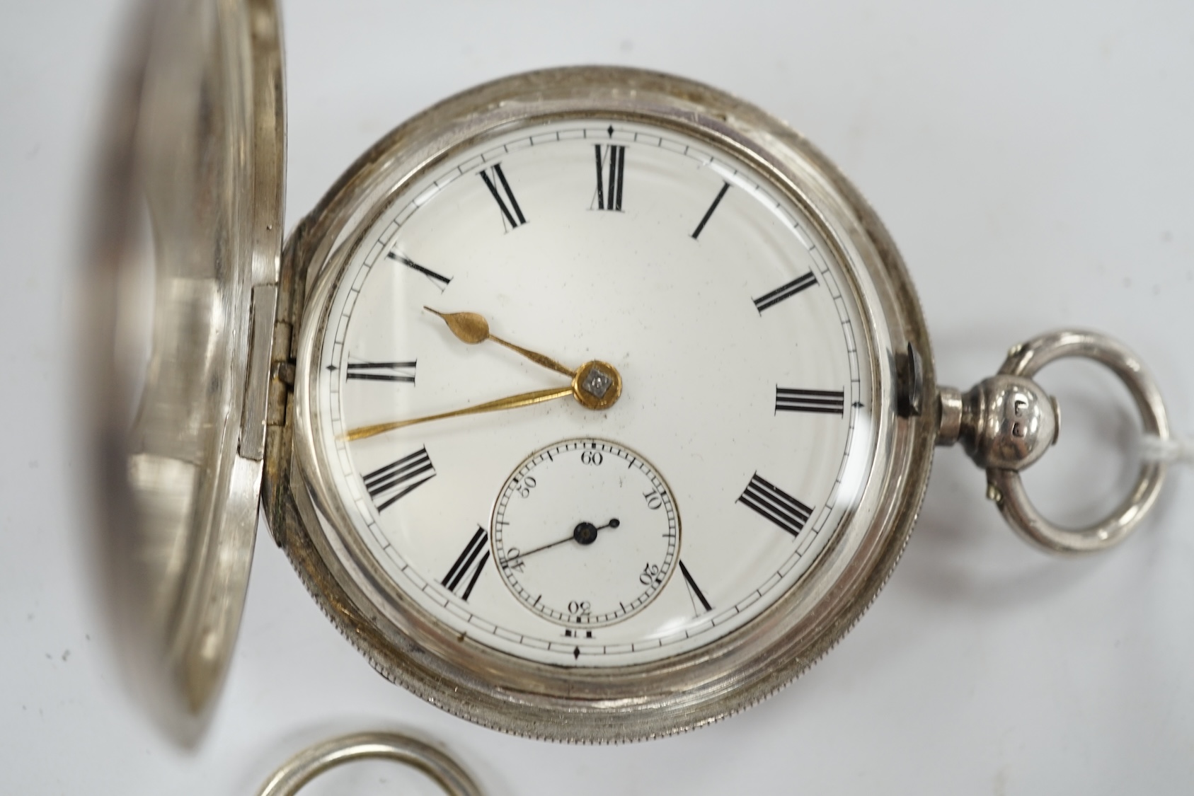 A late Victorian silver half hunter pocket watch and a later silver open faced pocket watch. Condition - poor to fair